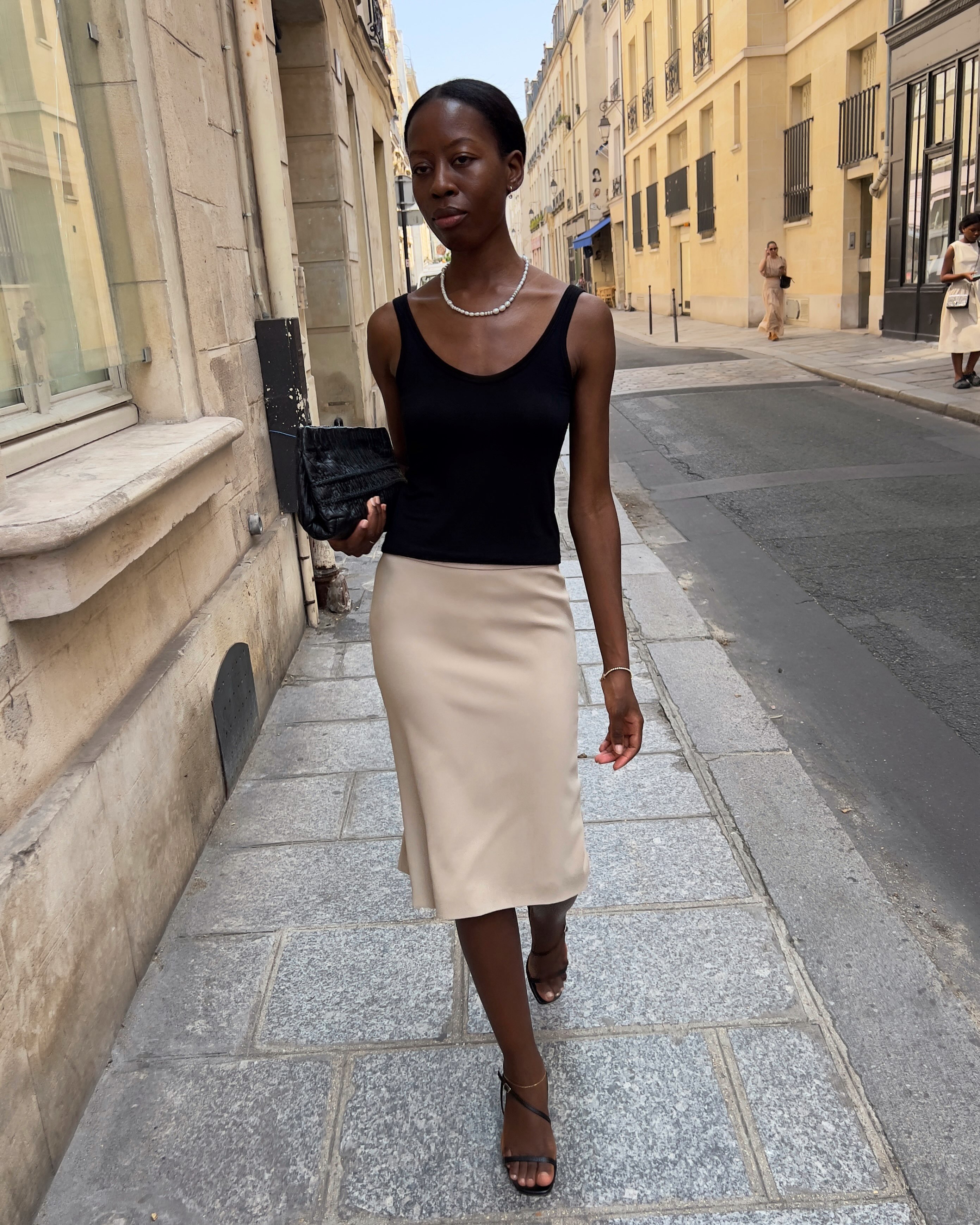 Woman wearing clearly visible black sandals